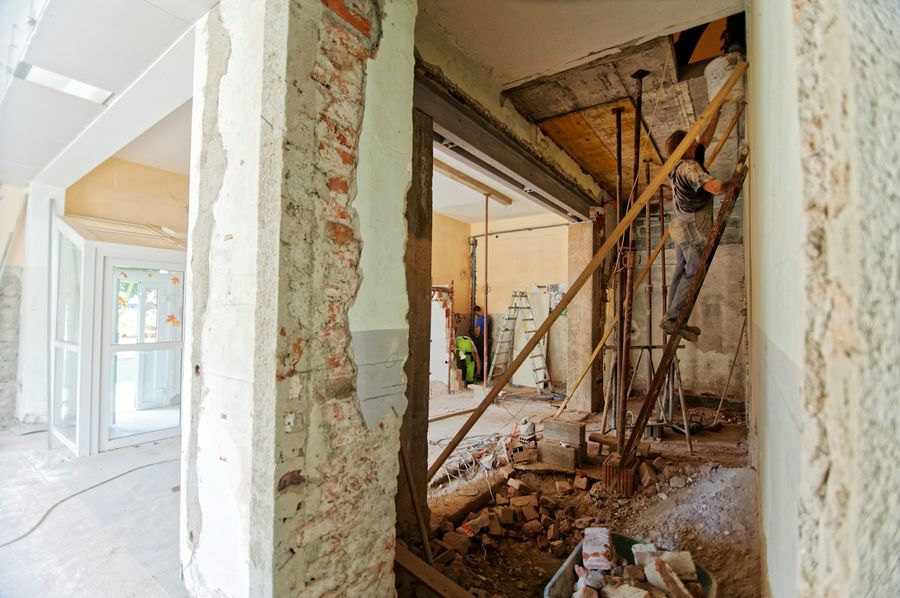 A room stripped back to its studs and brickwork part-way through a job